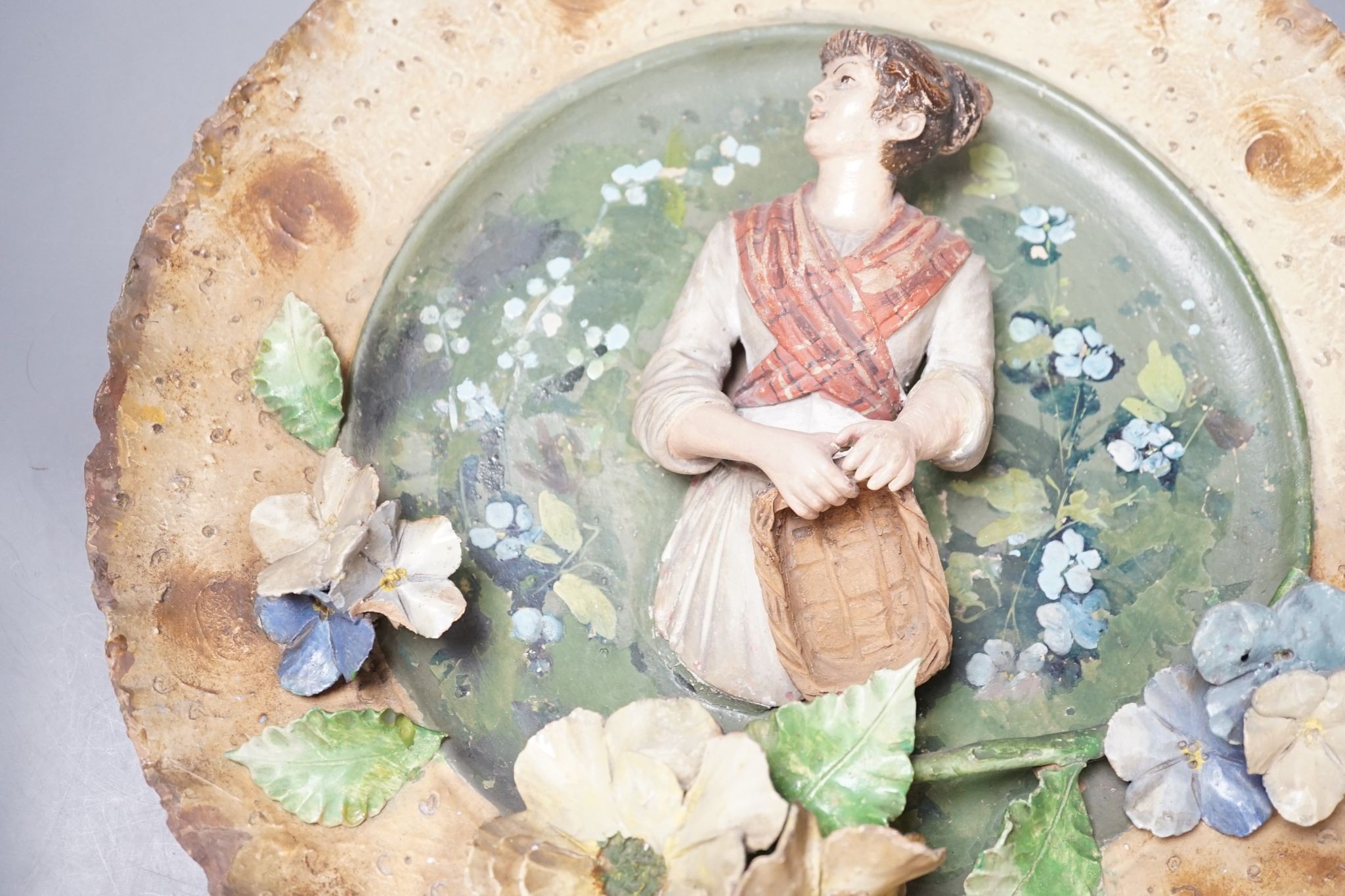 A Continental terracotta wall plaque and a Poutney & Co plaque (2) 39cm